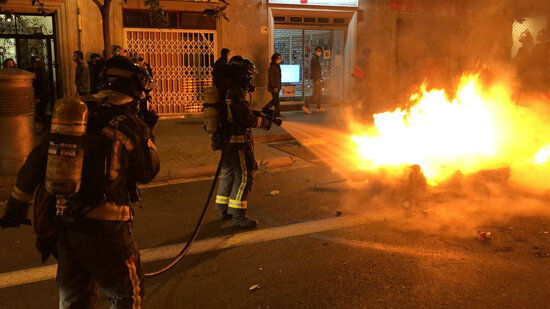 Firefighters put out a fire set in a dumpster in Barcelona's Fontana area, in Gràcia district, on Ferbruary 20, 2021 (by Alan Ruiz Terol)