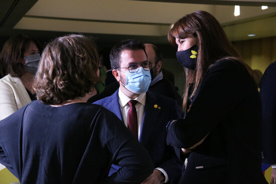 Pro-independence politicians Eulàlia Reguant of CUP, Pere Aragonès of ERC, and Laura Borràs of JxCat share a word in the Catalan parliament (by Bernat Vilaró)
