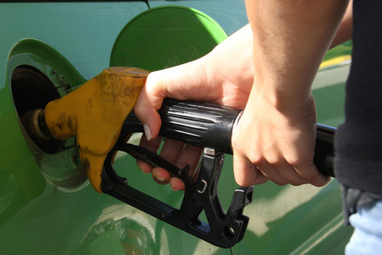 A person fills their vehicle with fuel