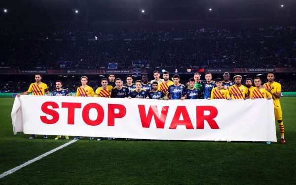 FC Barcelona and Napoli players hold up a banner denouncing Russia's war on Ukraine ahead of the Europa League meeting between the sides (image from FC Barcelona's Twitter account)