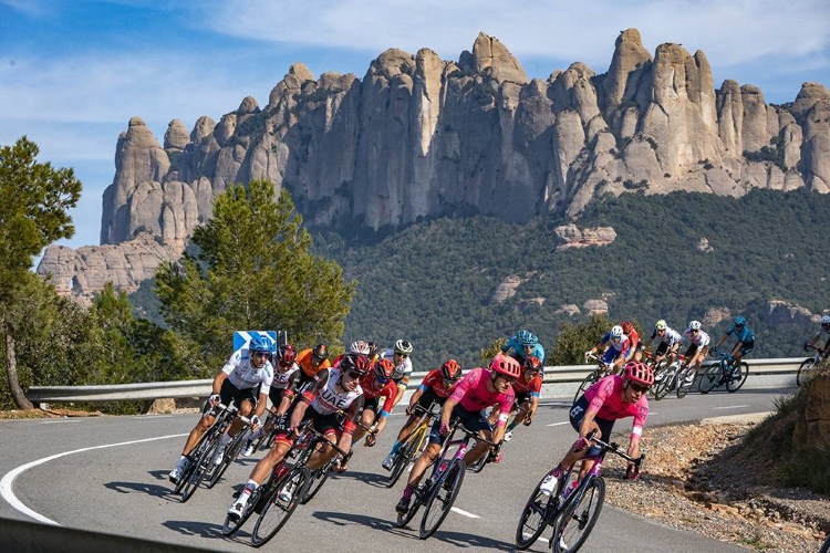 Cyclists during 2021 La Volta Ciclista a Catalunya in front of Montserat mountain (by La Volta Ciclista)