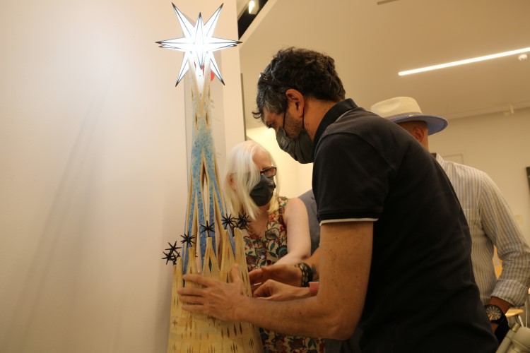 A group of visually impaired people touch the model of the Sagrada Familía's Virgin Mary tower, June 28, 2022 (by Eli Don)  