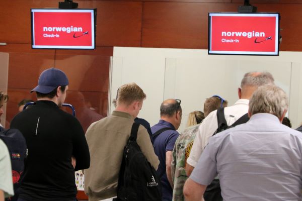 Passengers checking into their Norwegian Air flight at Barcelona airport