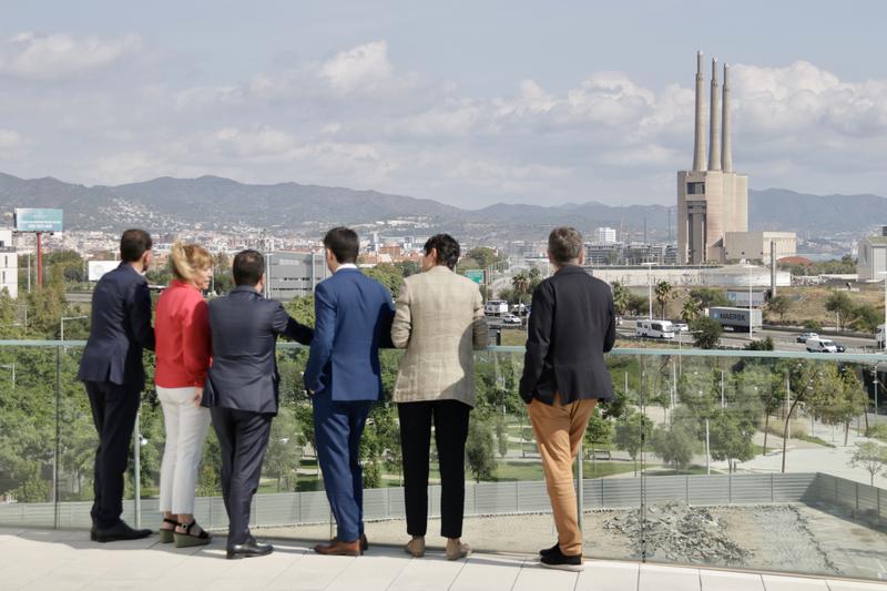 Members of the Catalan government and leaders of several city councils watch the 'Les Tres Xemeneies' old factory from Campus UPC university 