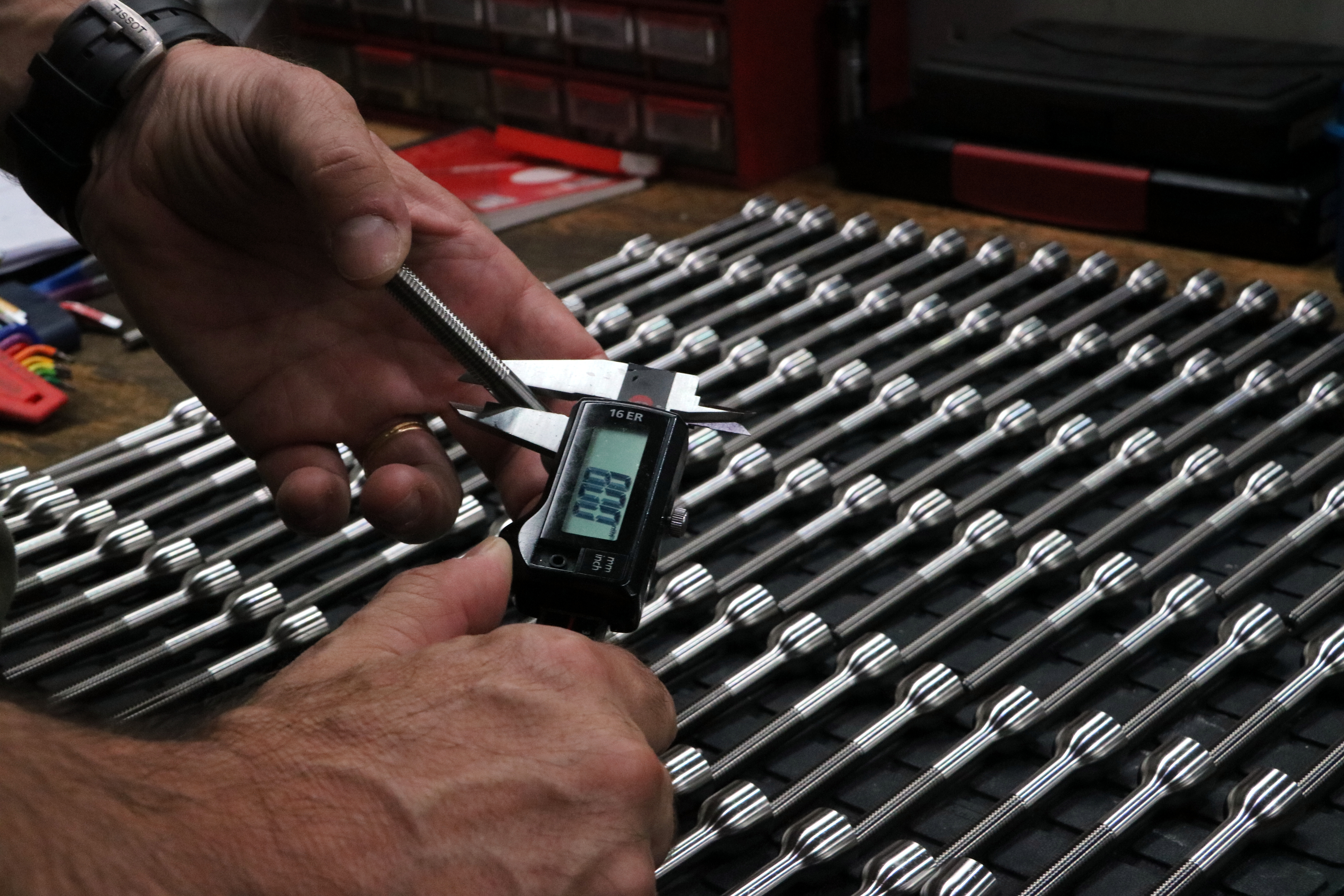 A worker handles a parts produced in a factory