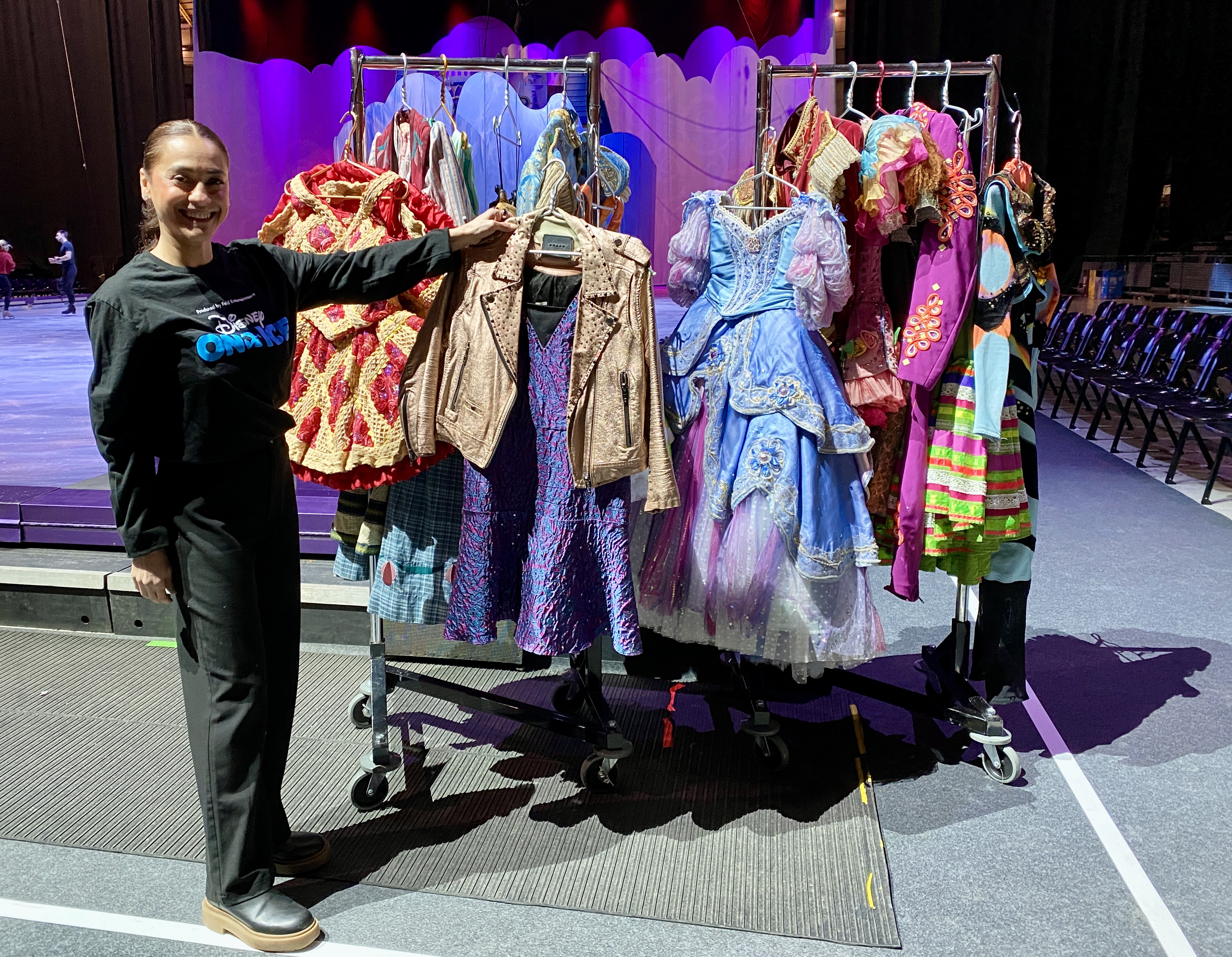 Alicia Sánchez, host and ice skater with Disney On Ice, poses in front of some of the show's costumes