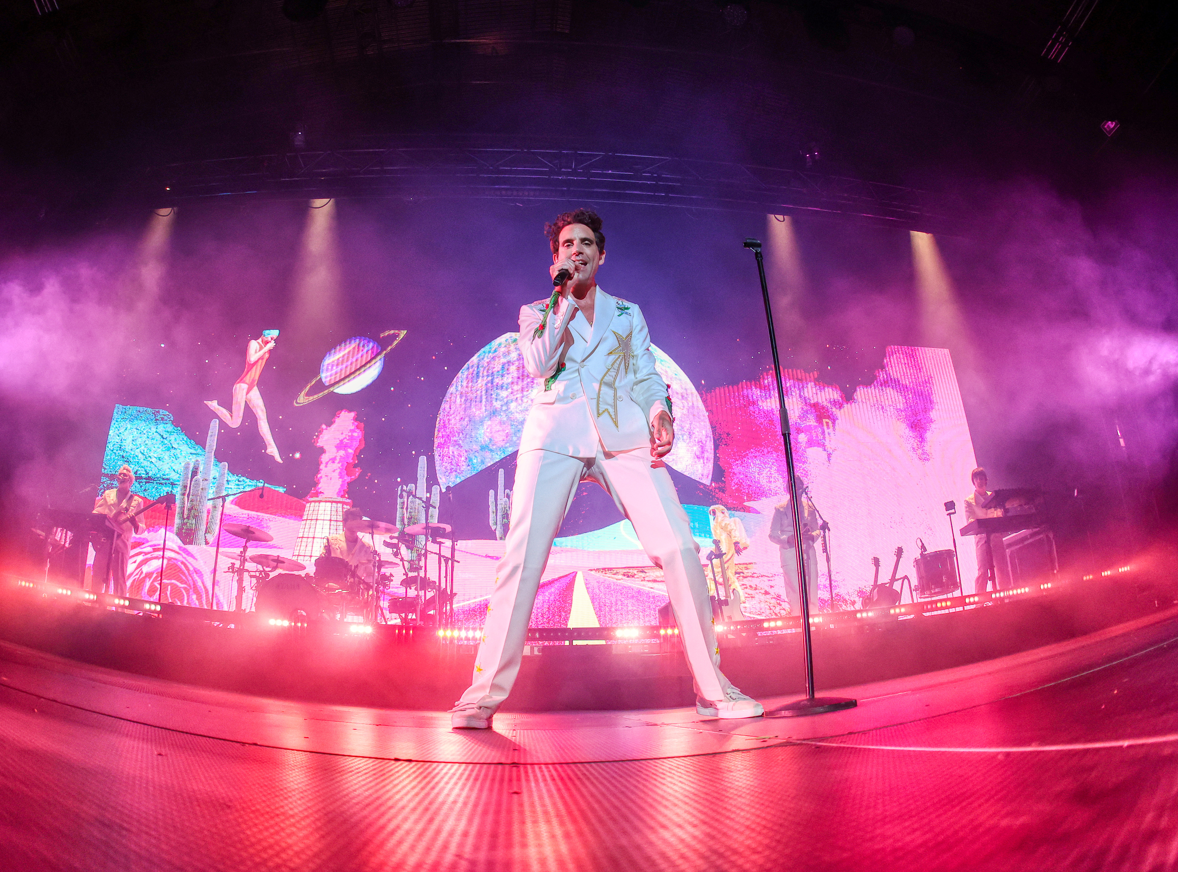 Singer Mika wears a white suit at a concert in Barcelona on July 17, 2024