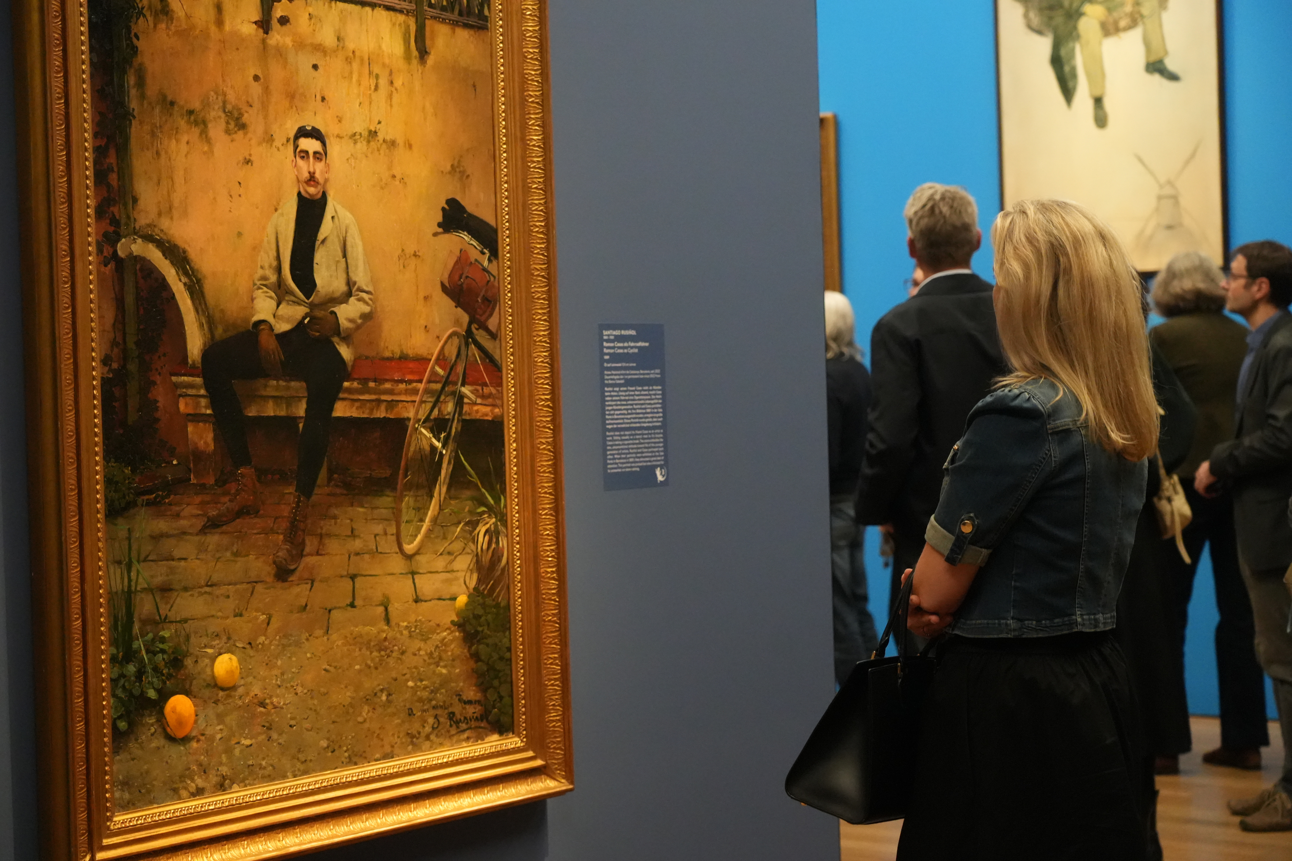 A visitor observing several works from the exhibition 'Modern Barcelona: From Gaudí to Picasso' at the Kunsthalle München