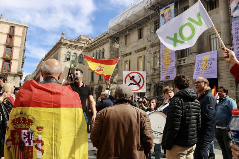Flags of Spain, far-right Vox, and against Communism displayed at the protest against amnesty in Barcelona