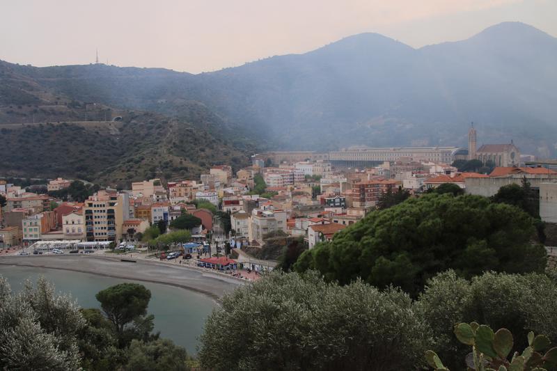 Smoke from the wildfire in northern Catalonia reaching the town of Portbou