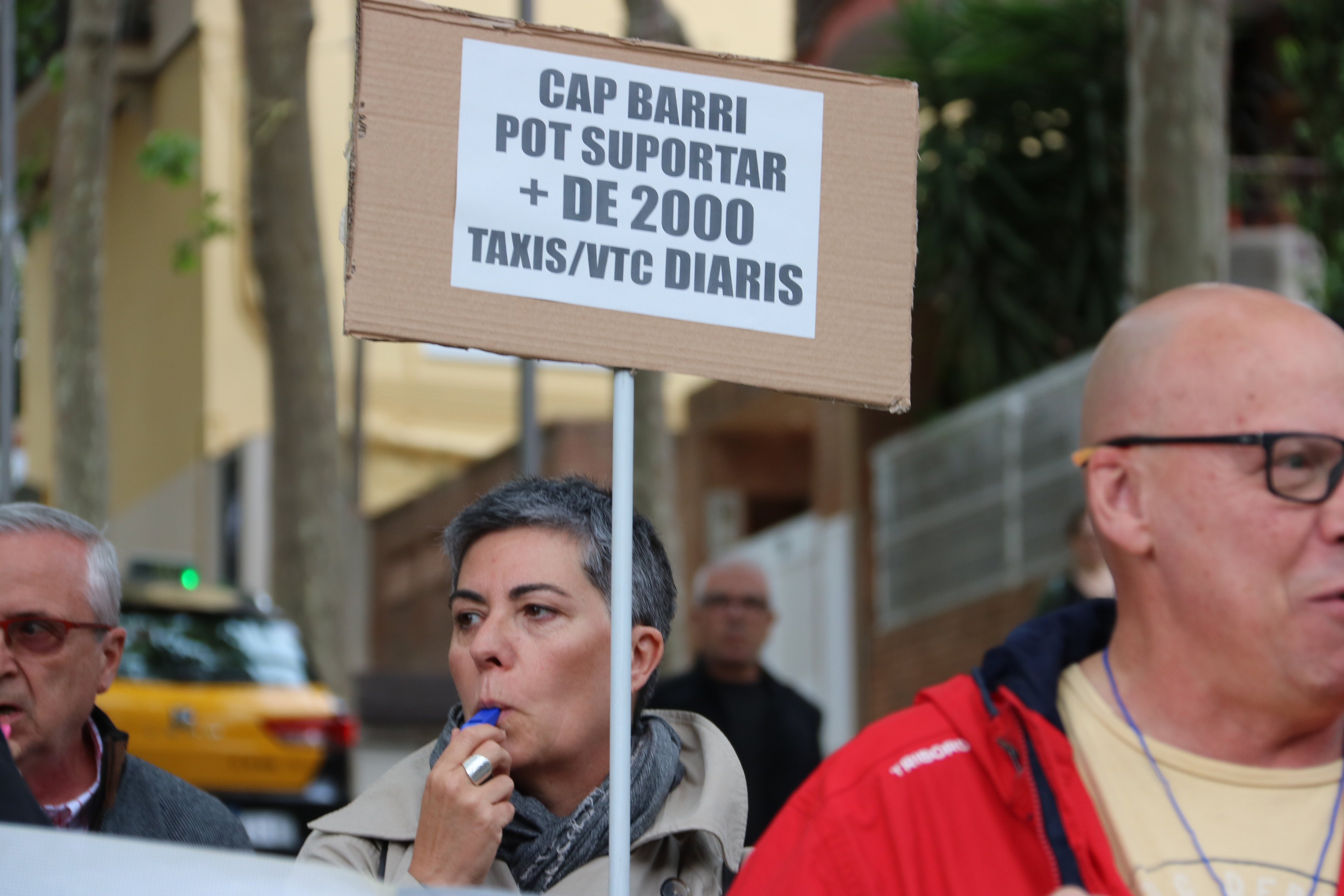 A La Salut neighbor protesting against the over 2,000 daily taxis driving in the area near the Park Güell monument in May 2023