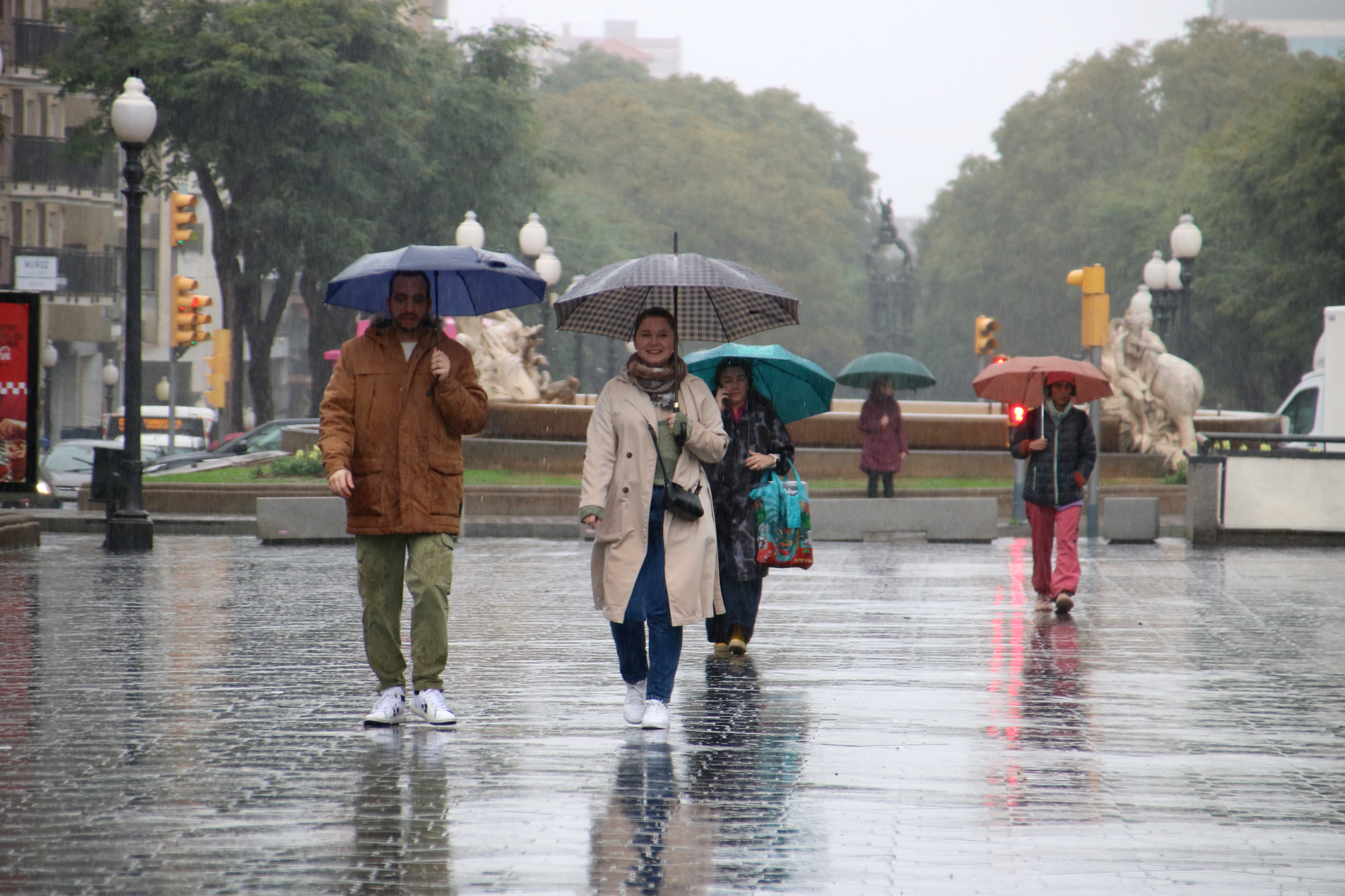 People walking through Tarragona in the rain