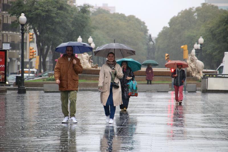 People with umbrellas walking under the rain in Tarragona on January 19, 2024