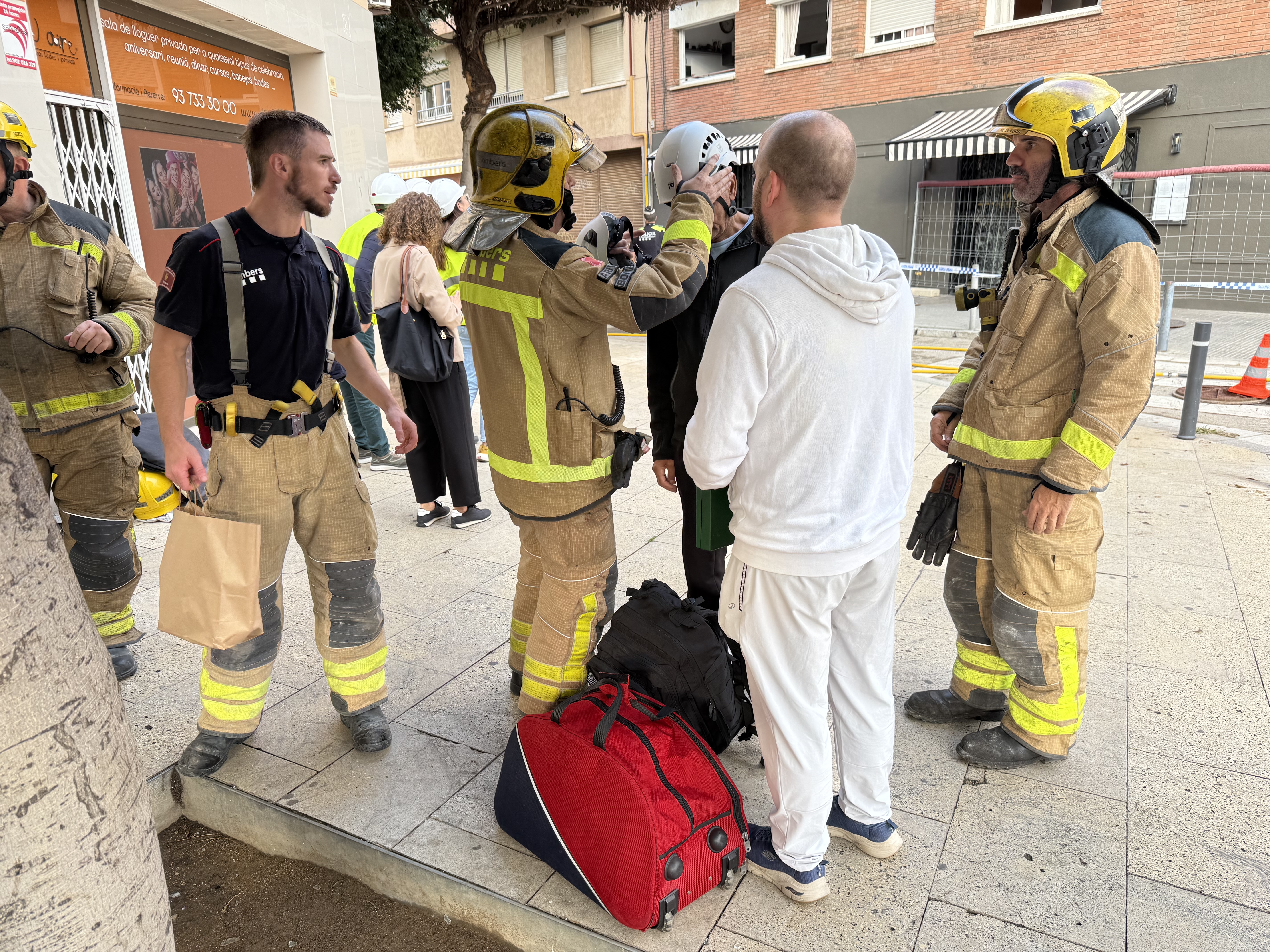 Residents after entering their homes to collect essential items