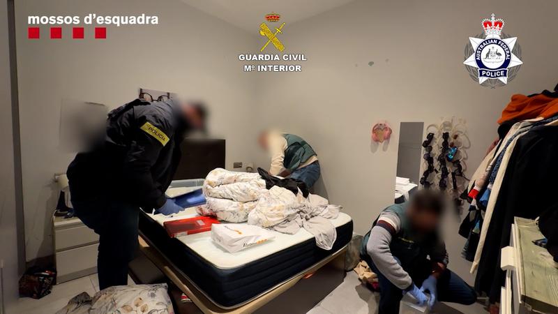 Police during a police raid against an international drug trafficking organization in Barcelona selling drugs via postal service to Australia