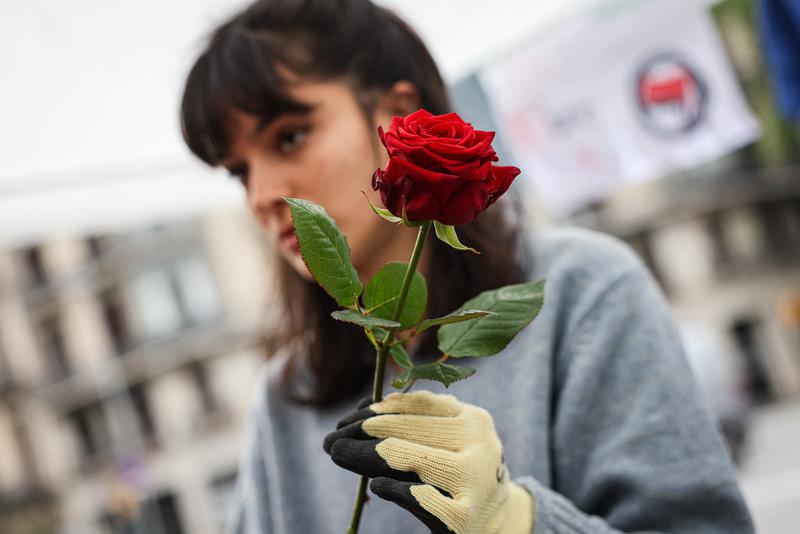 A woman prepares a Sant Jordi rose in Barcelona on April 23, 2022