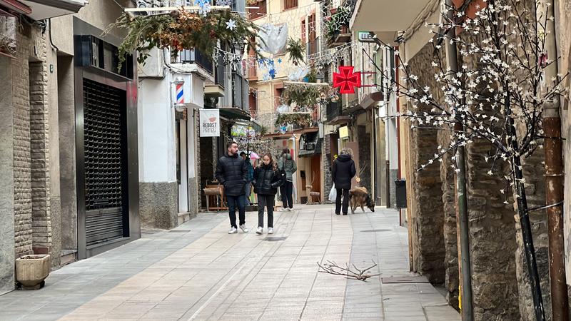 People taking a walk in the center of Catalan town of Sort.