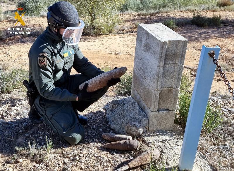 A Guardia Civil officer handling one of the Civil War-era explosive devices in southern Catalonia