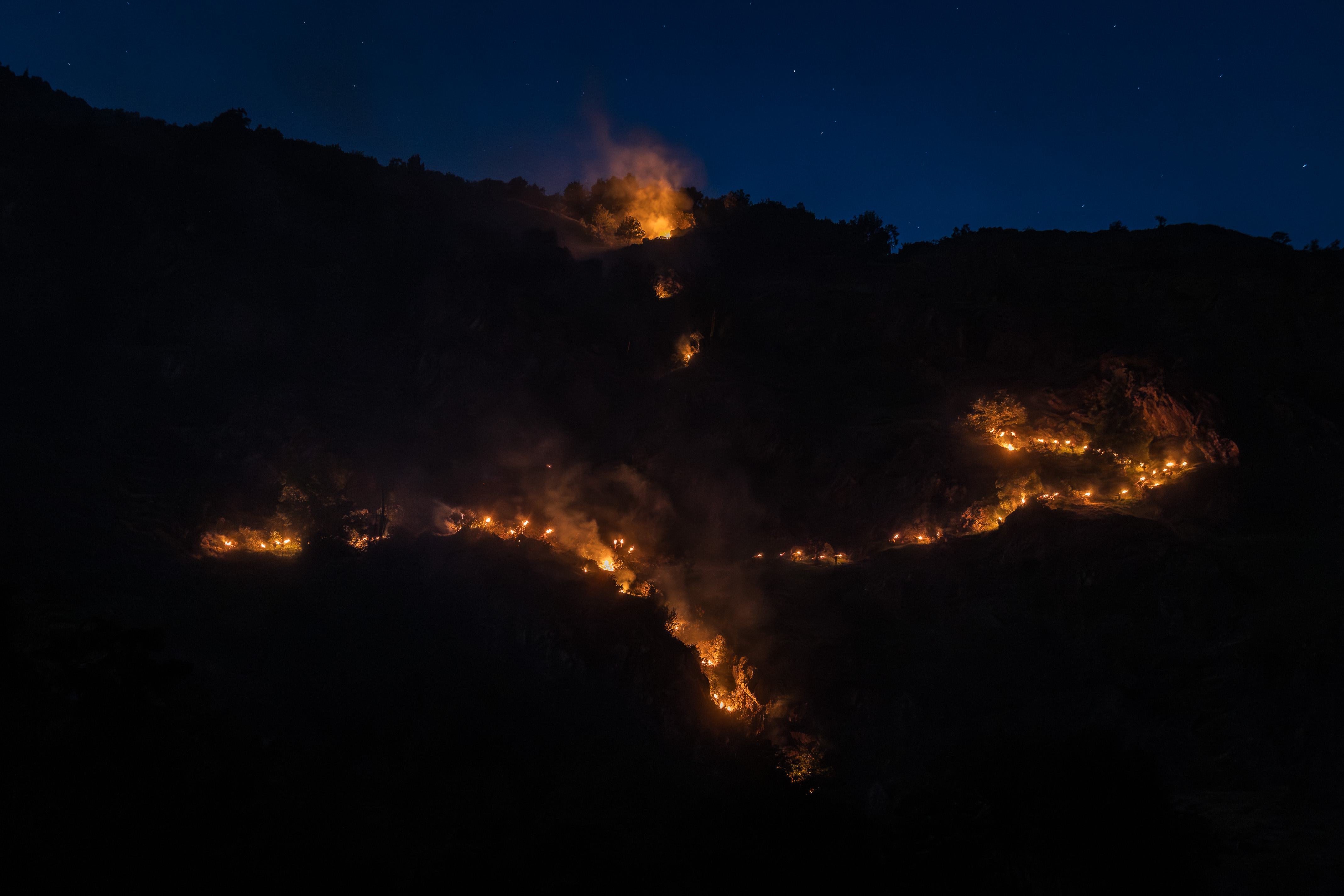 The descent of the falles, a path of fire on the mountain that can be seen from the town of Isil.