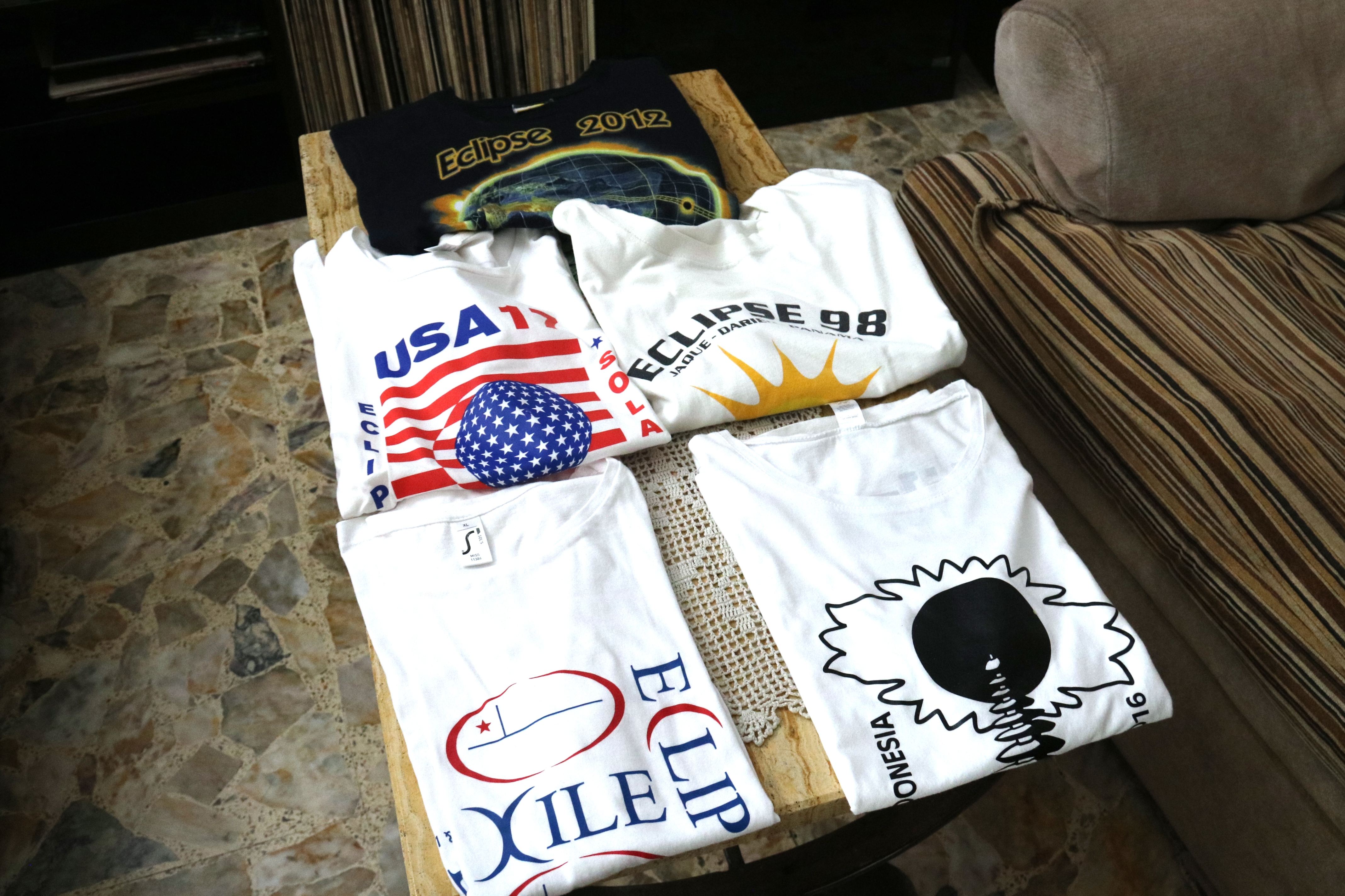 Commemorative eclipse T-shirts collected by astronomy tourists Carme Lluís and Jaume Sacasas over the past three decades