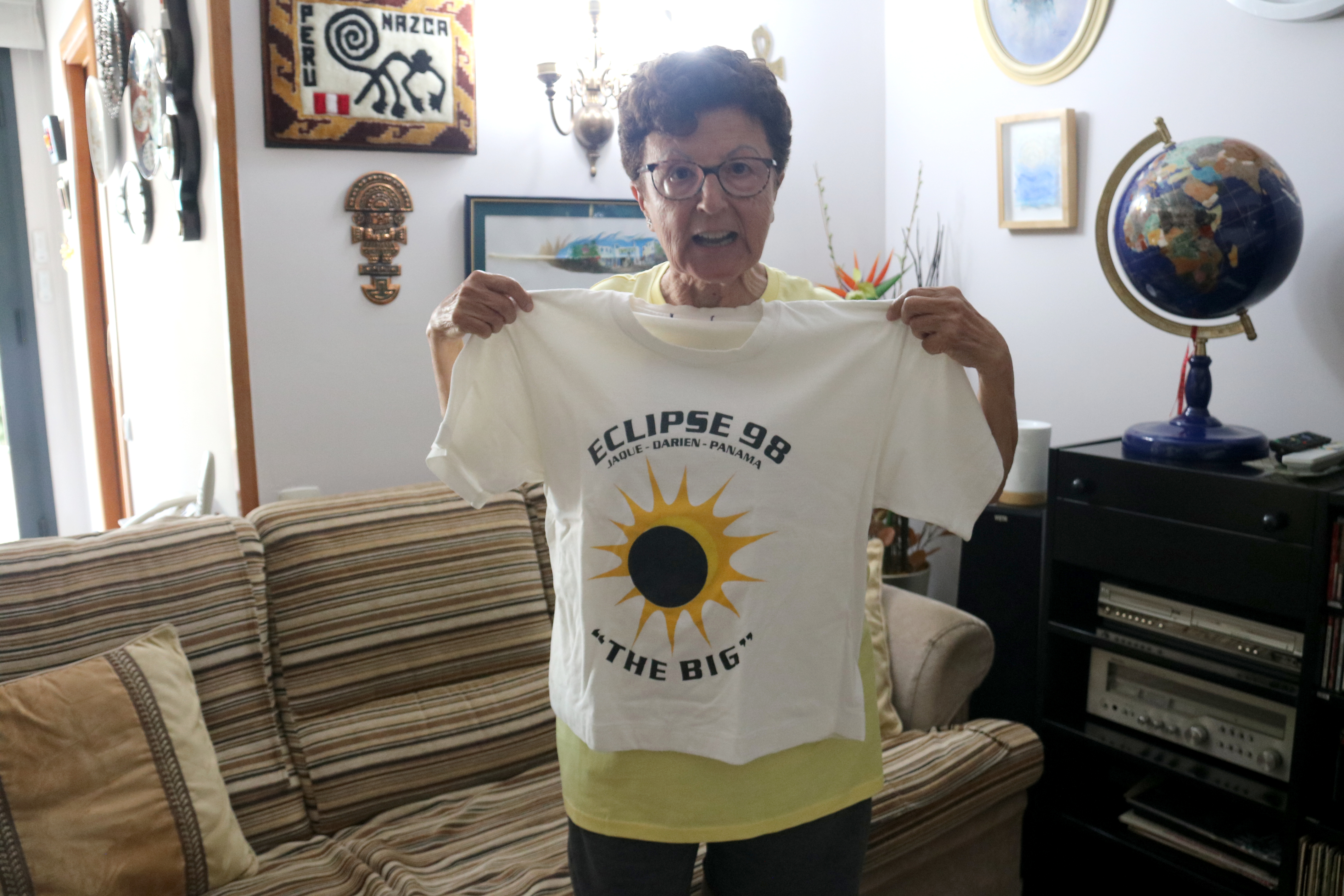 Eclipse chaser Carme Lluís shows a commemorative T-shirt from the 1998 eclipse she witnessed in Panama