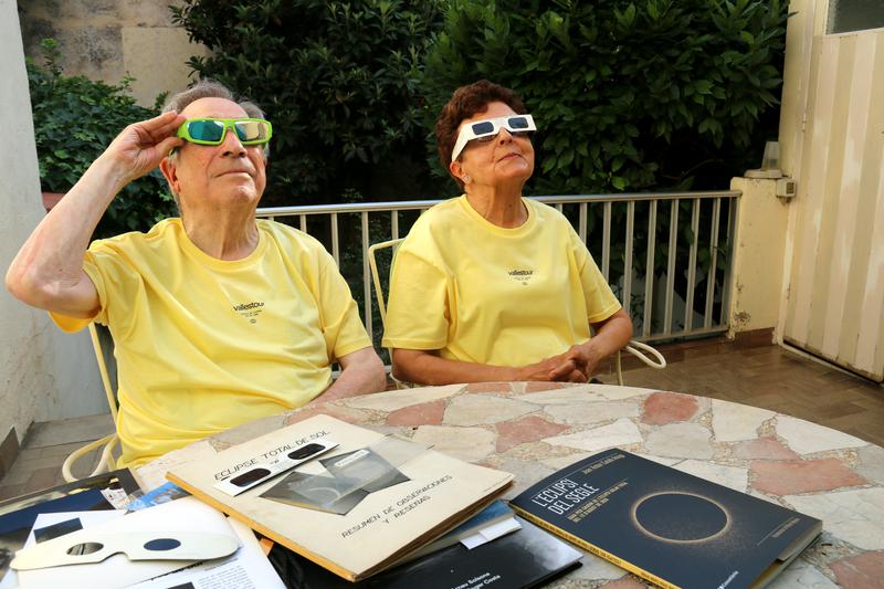 Eclipse chasers Jaume Sacasas and Carme Lluís test the protective glasses they will use to watch the August 12 eclipse