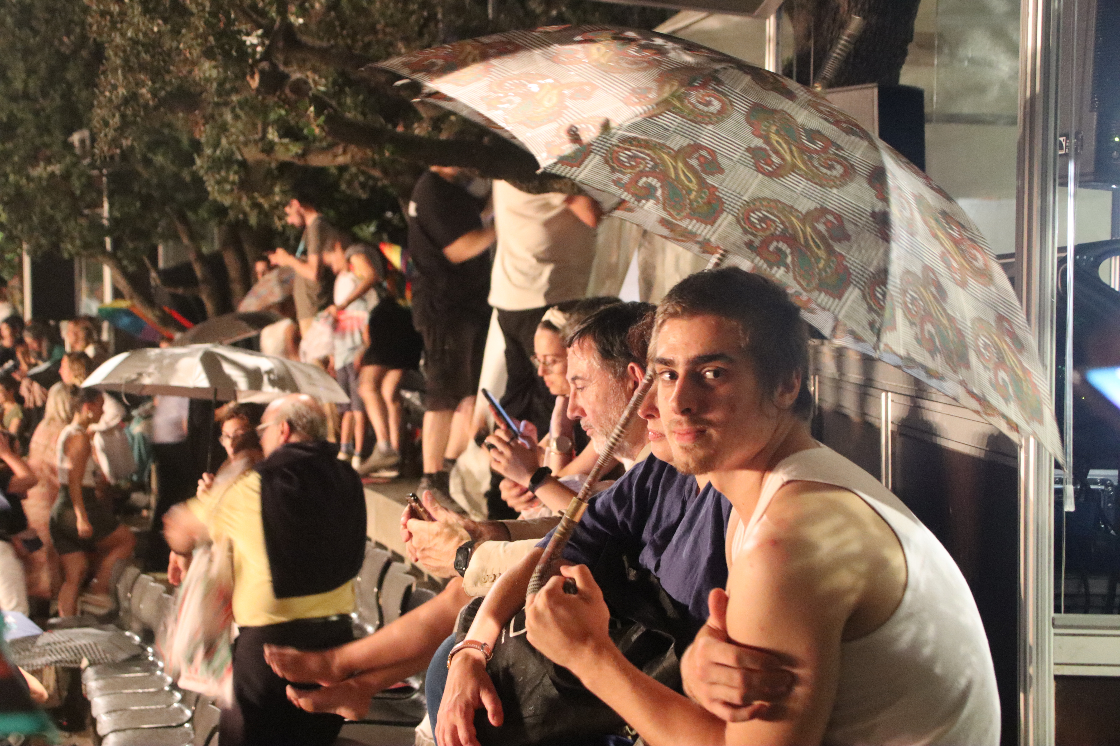 Many spectators at Festival Grec's 'The Pulse' opening act holding umbrellas because of the rain on June 29, 2023