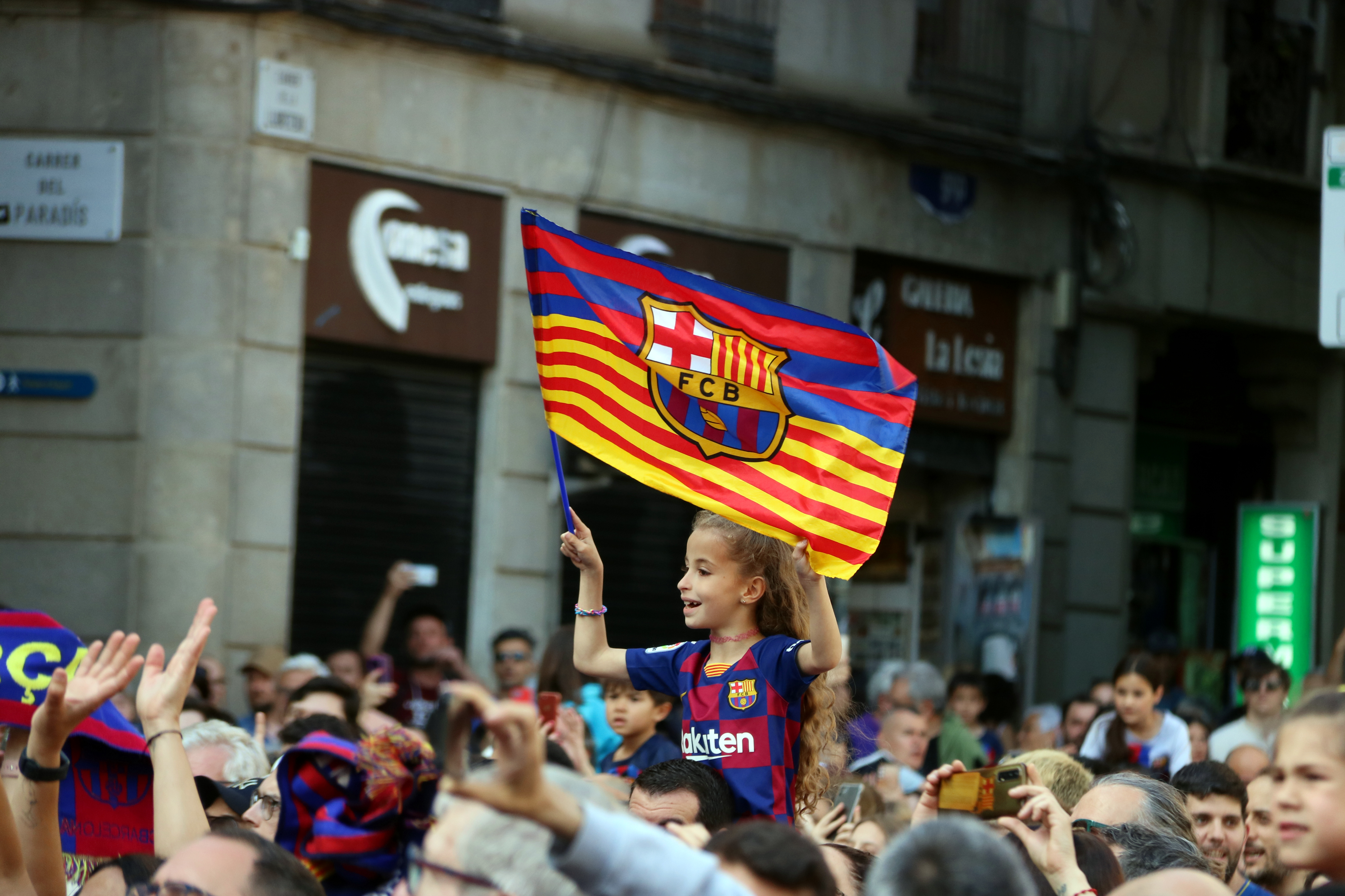 A little girl celebrates at the Plaça Sant Jaume in Barcelona on June 4, 2023 the Champions League trophy the FC Barcelona Women's team won in Eindhoven