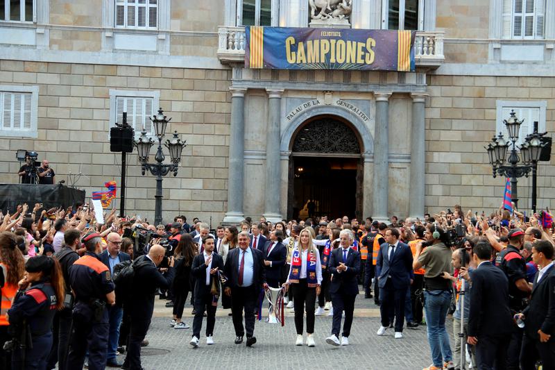 FC Barcelona Joan Laporta and Barça women's team captain Alexia Putellas carry the UEFA Women's Champions League trophy across Plaça Sant Jaume from the Catalan government to Barcelona's city hall on June 4, 2023
