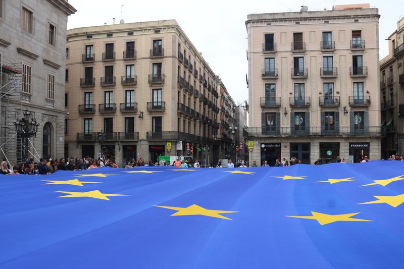 A large EU flag commemorating Europe Day in Barcelona's Plaça Sant Jaume square
