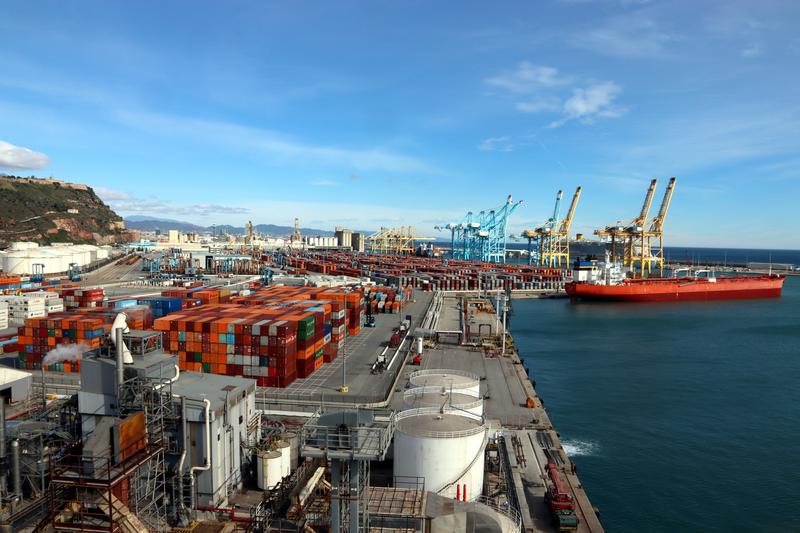 The Zona Franca at the Port of Barcelona, with dozens of shipping containers and cranes 