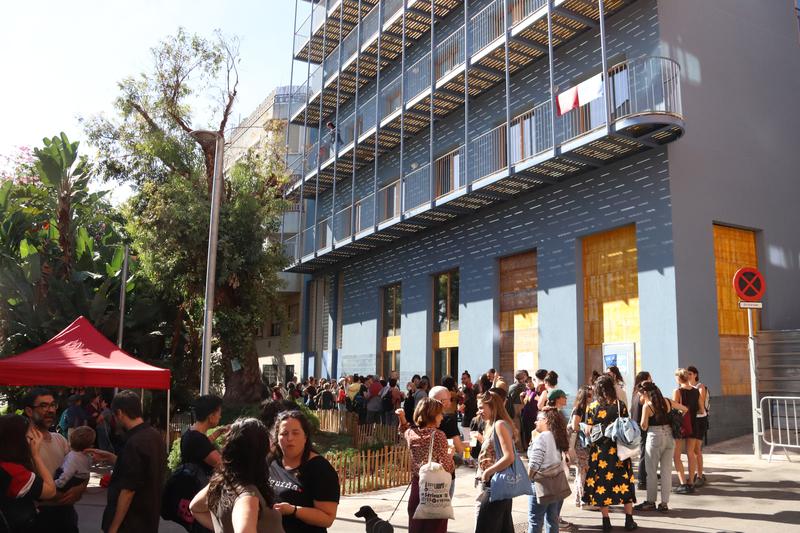 A queue of people waiting to enter the feminist cooperative housing project 'La Morada' in the Barcelona neighborhood of Nou Barris