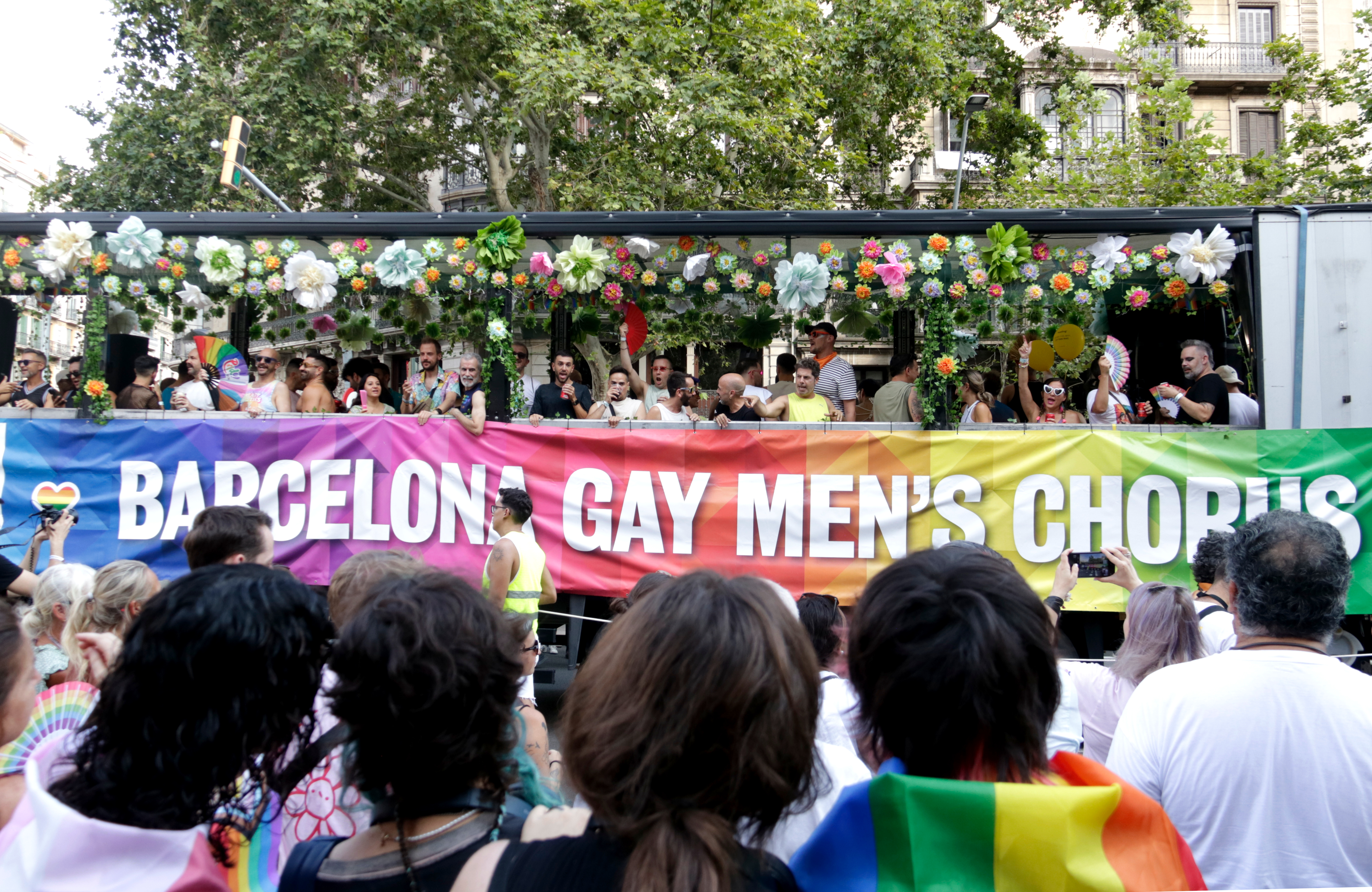Pride attendees watch one of the floats pass by in 2025's Pride Parade