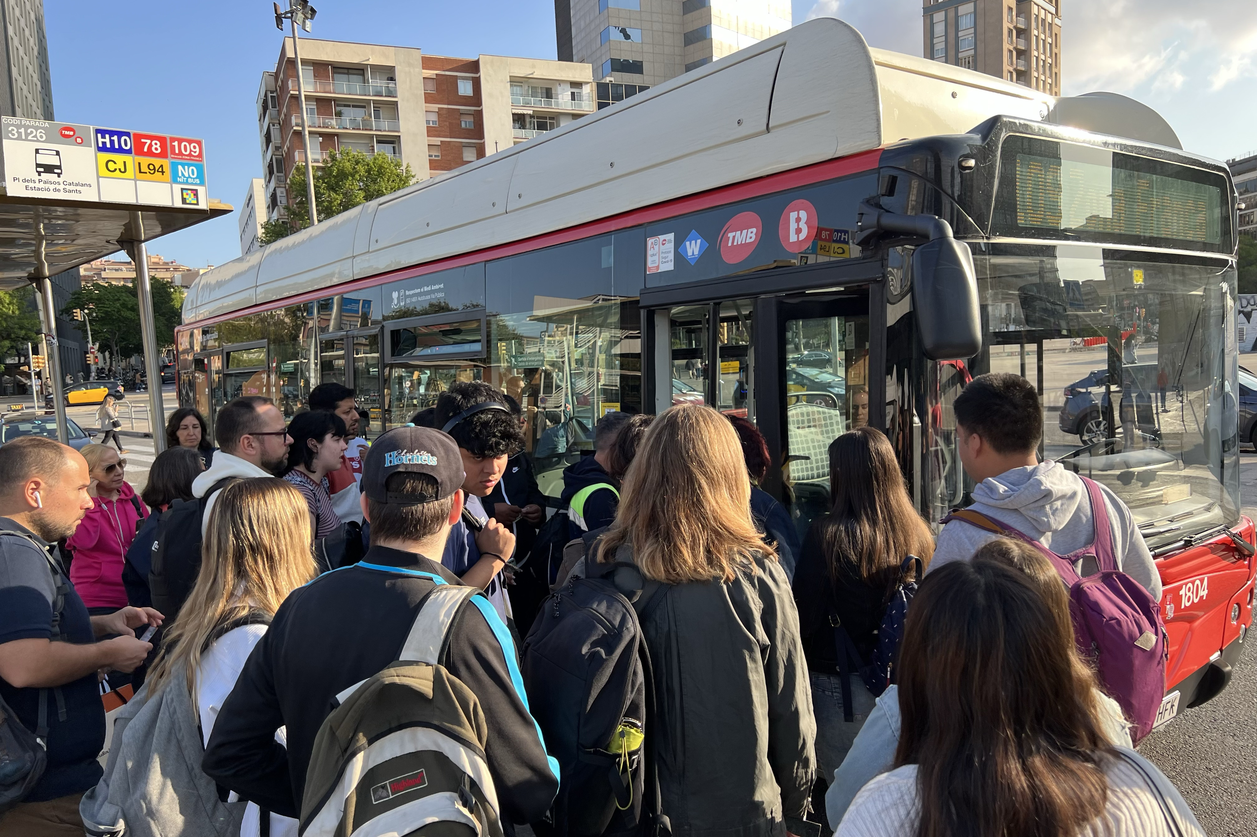 Passengers wait in a bus stop in Barcelona during a strike called on by bus drivers on May 18, 2023