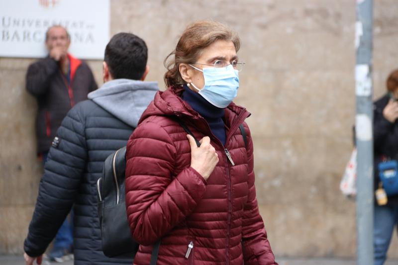A woman leaving the hospital wearing a face mask