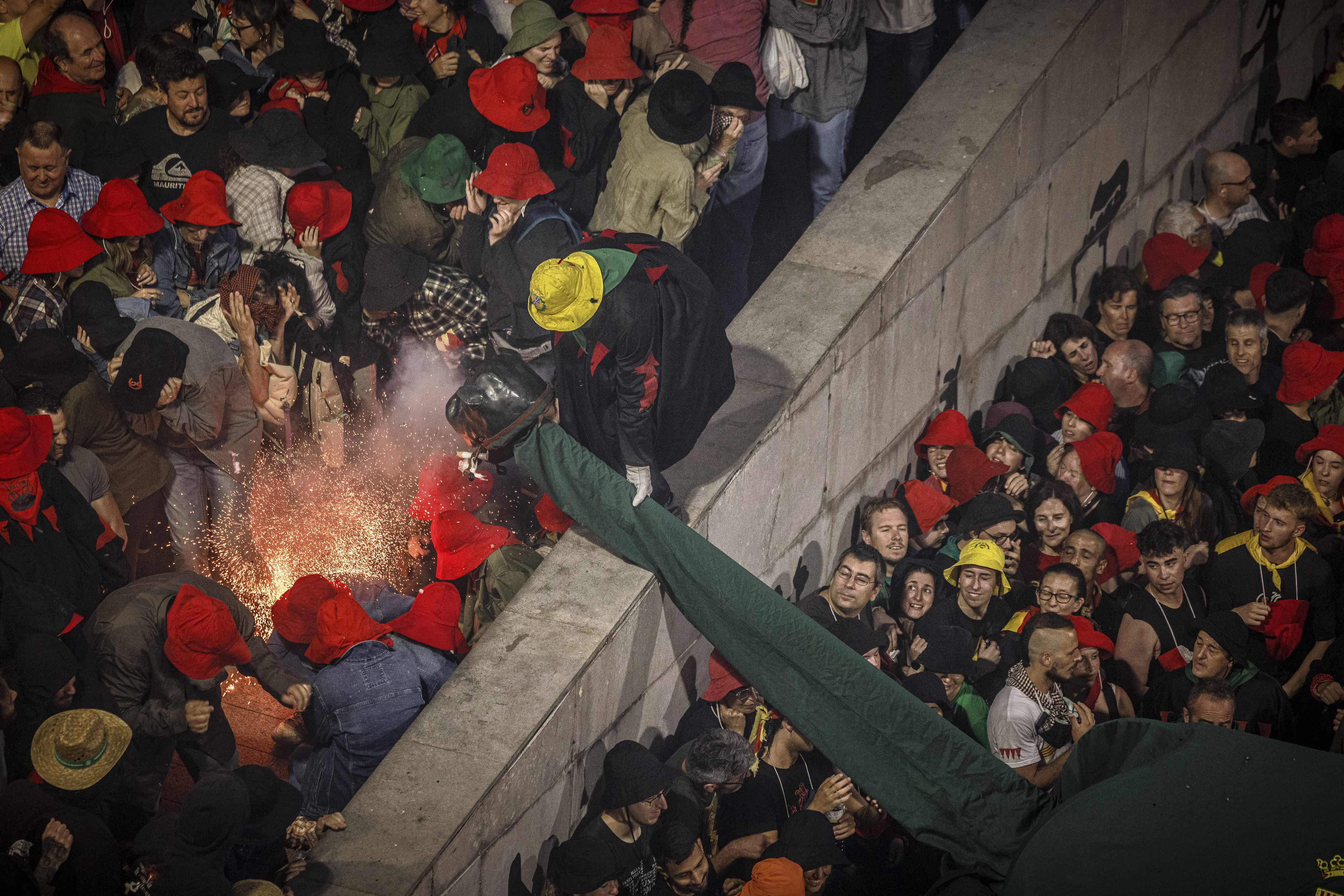 One of the demons of the Patum in Berga with firecrackers in its mouth