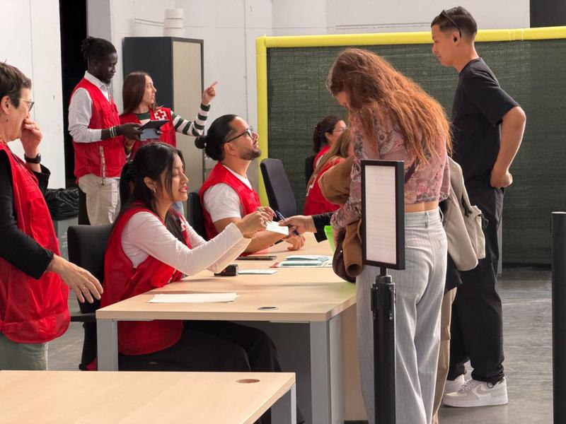 Migrants at the regularization process desks at the Fira de Montjuïc in Barcelona