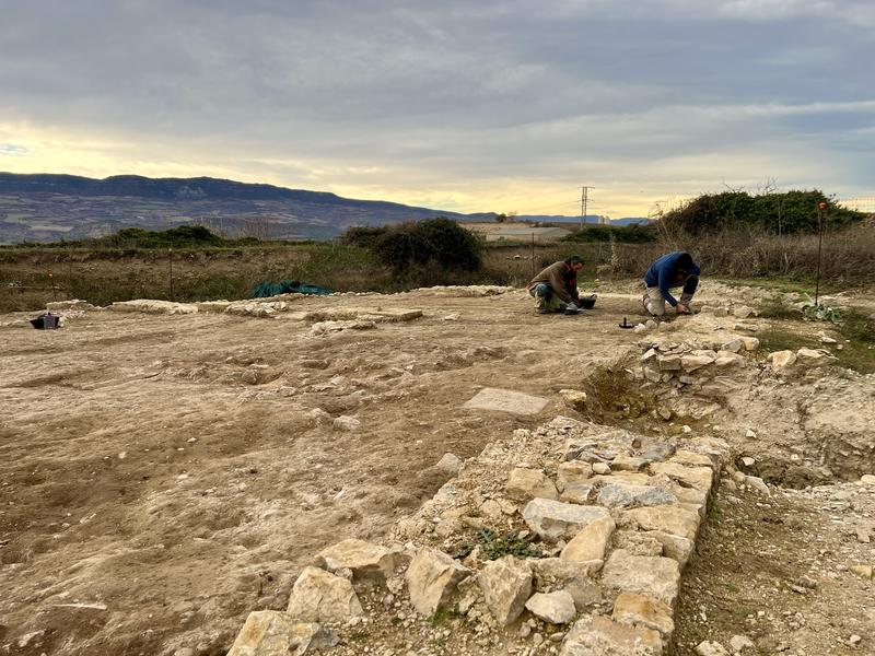 Two archeologists excavating a Roman house in l'Hort del Cavaller d'Isona