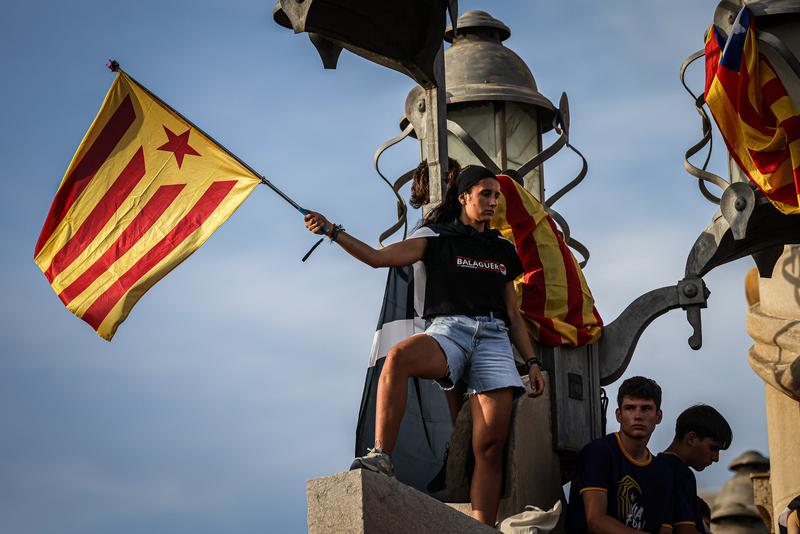 A demonstrator waves a Catalan pro-independence flag on the National Day celebrations of 2023