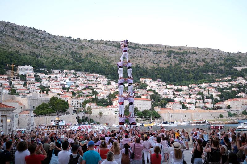 The Minyons de Terrassa human towers group performing a eight-tier castell with four people per tier in Dubrovnik's port on July 8, 2023