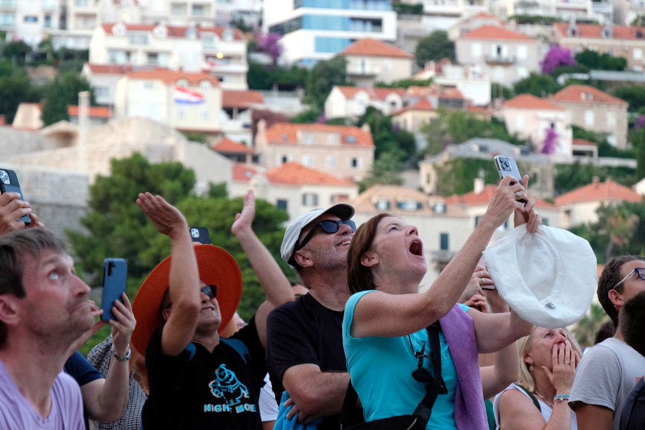 Some tourists in Dubrovnik, Croatia, enjoying a Castellers performance by the Minyons de Terrassa on July 8, 2023