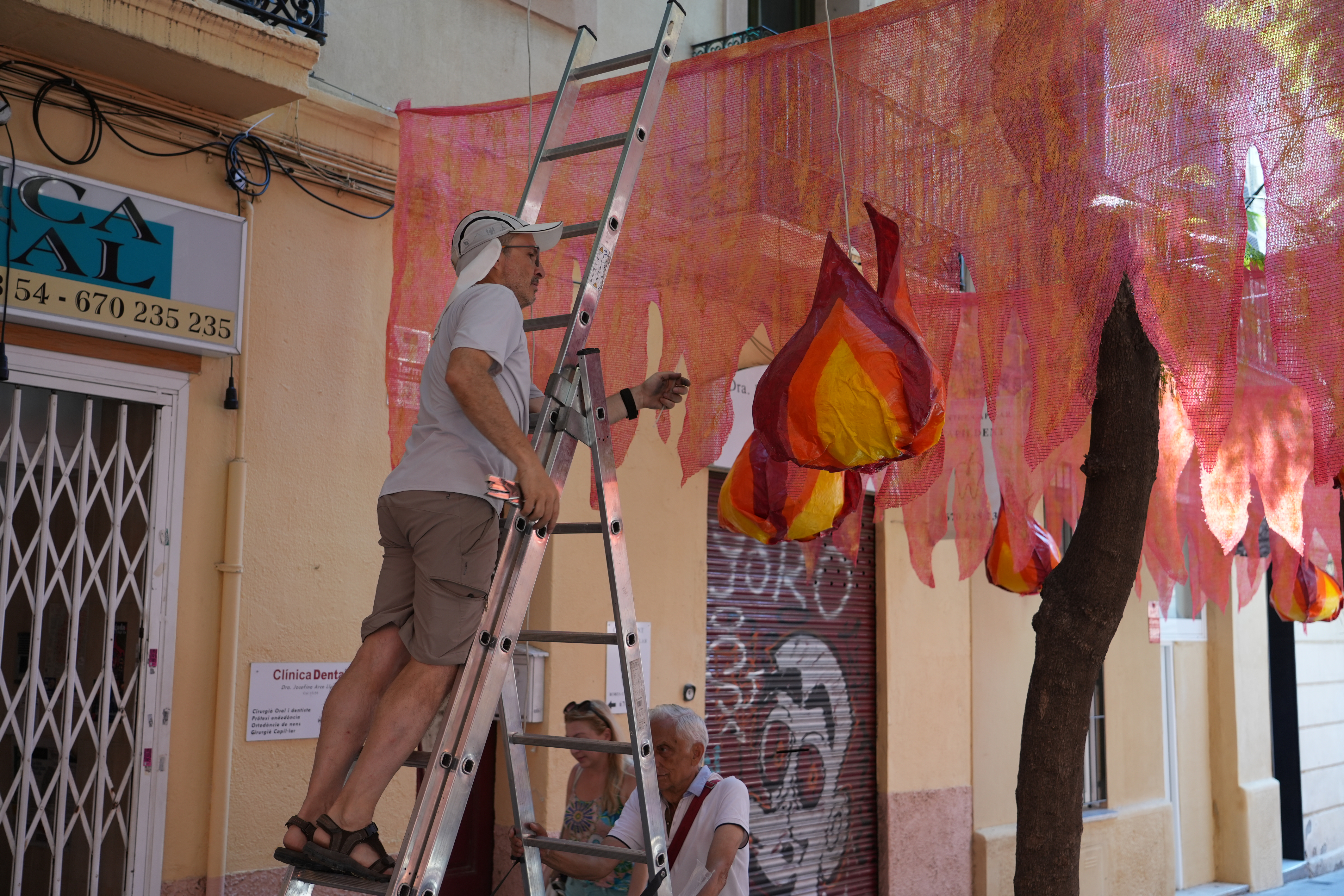 Residents work on the decorations on Carrer de Joan Blanques in Gràcia