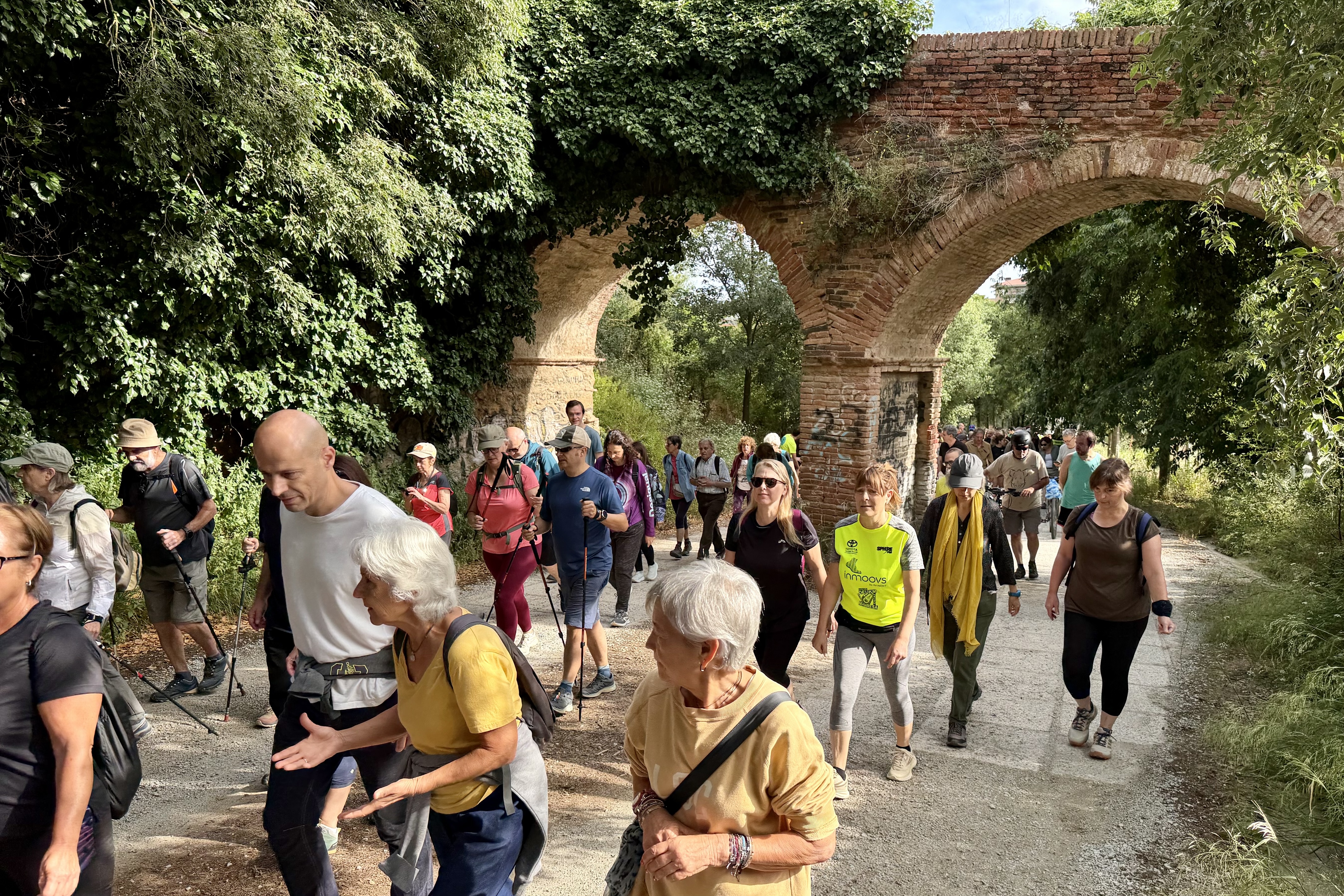 Participants in a protest walk calling for the reopening of Collserola pass under the Can Catà aqueduct in Cerdanyola del Vallès