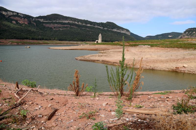 The bell tower and the church of Sant Romà de Sau clearly visible as water levels in Sau reservoir fall