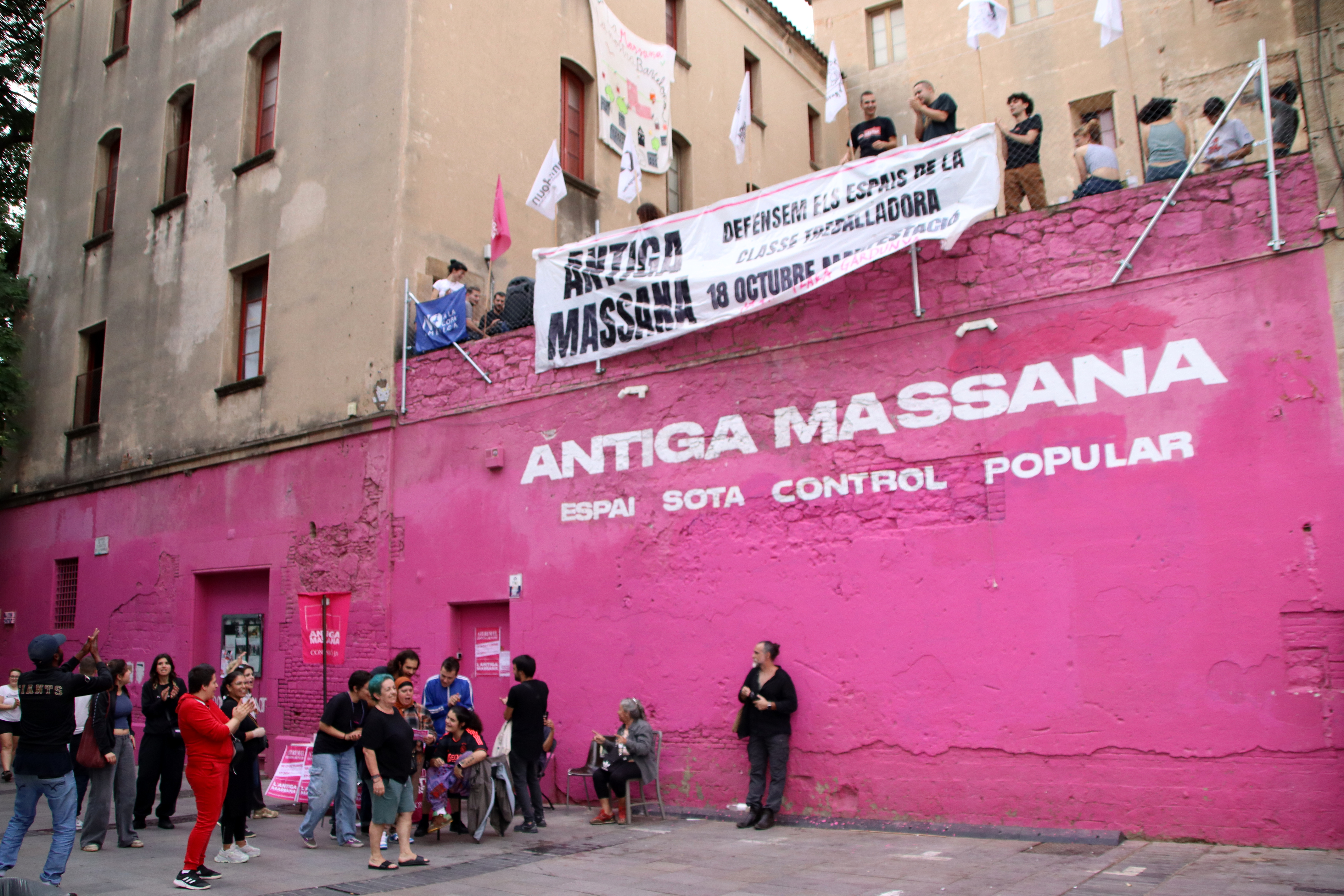 Activists outside the Antiga Massana building block the entrance to it to prevent an eviction