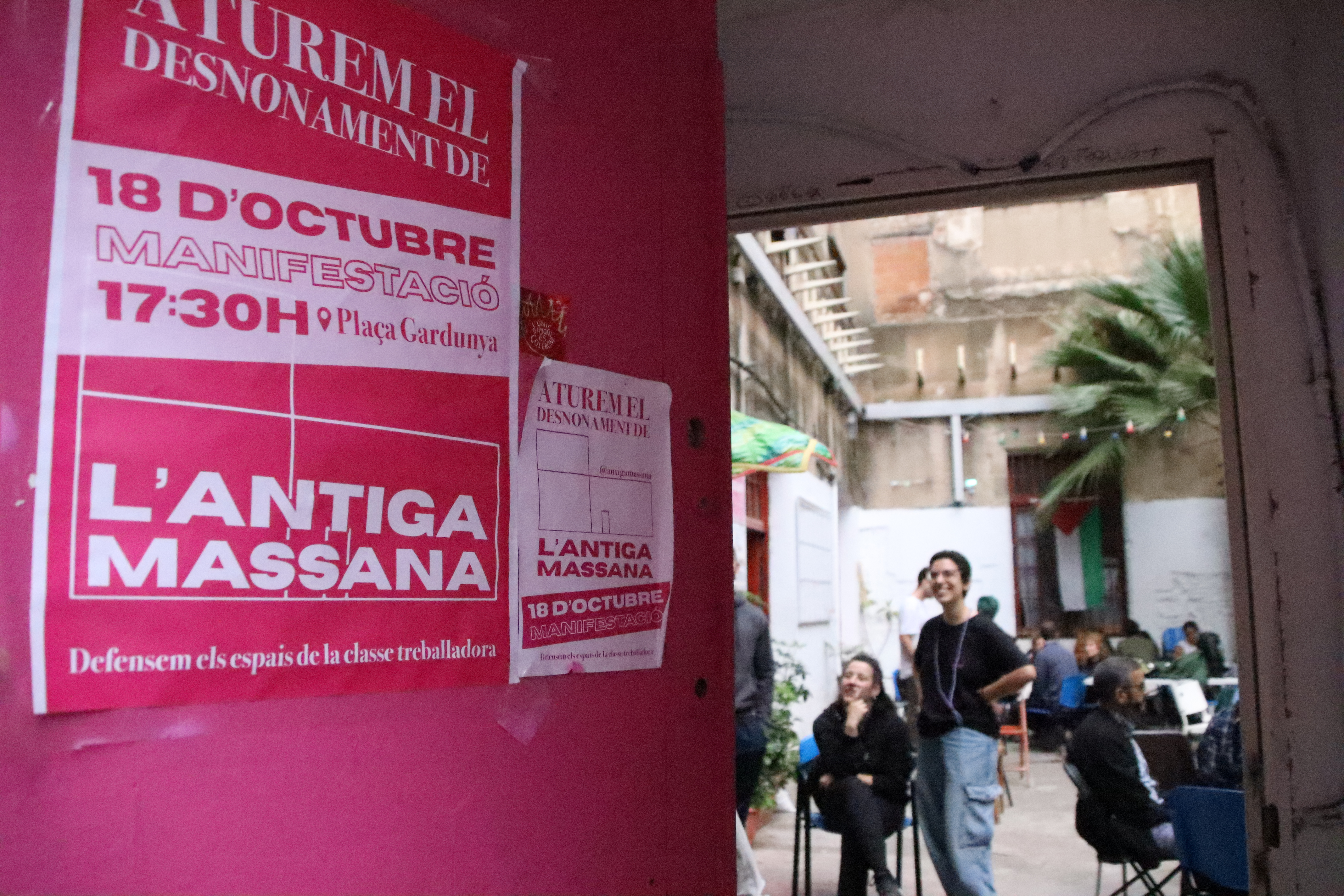 The front door of the Antiga Massana building, with a poster calling for a protest to defend it