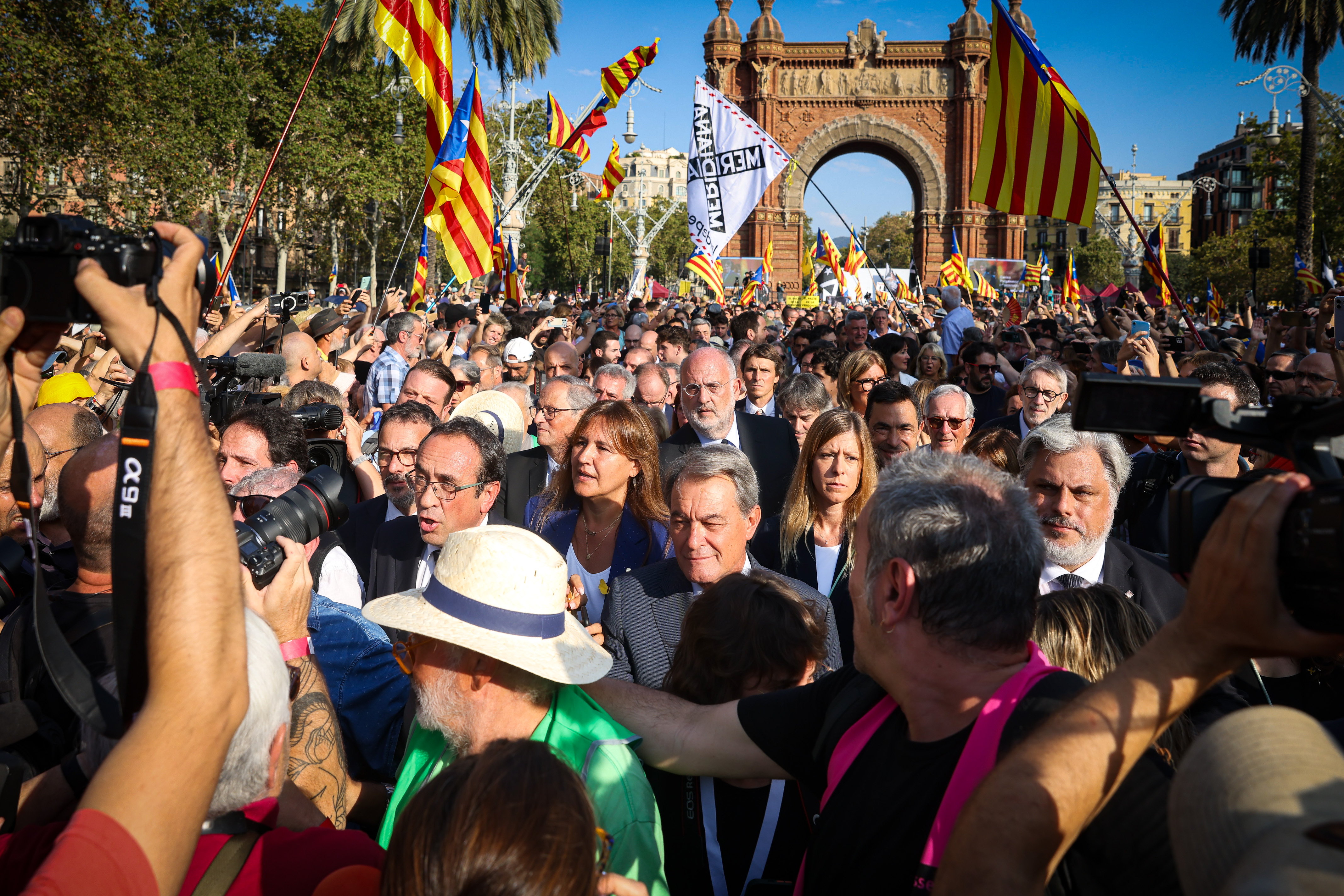 Members of pro-independence Junts party including Laura Borràs, former president Artur Mas, and current parliament speaker Josep Rull during a walk after Puigdemont’s speech on August 8, 2024