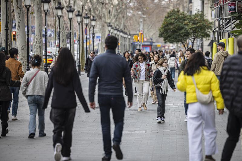 A group of people walking through Barcelona