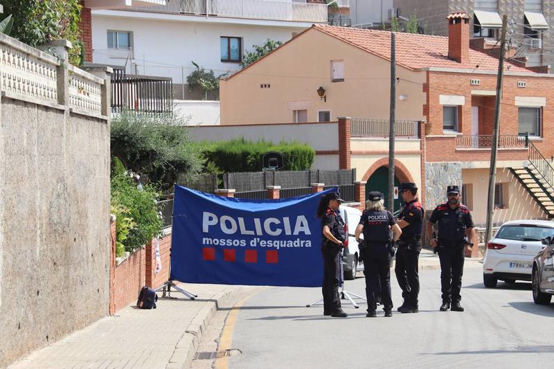 Catalan police cover a residence in Castellbisbal where two bodies were found dead