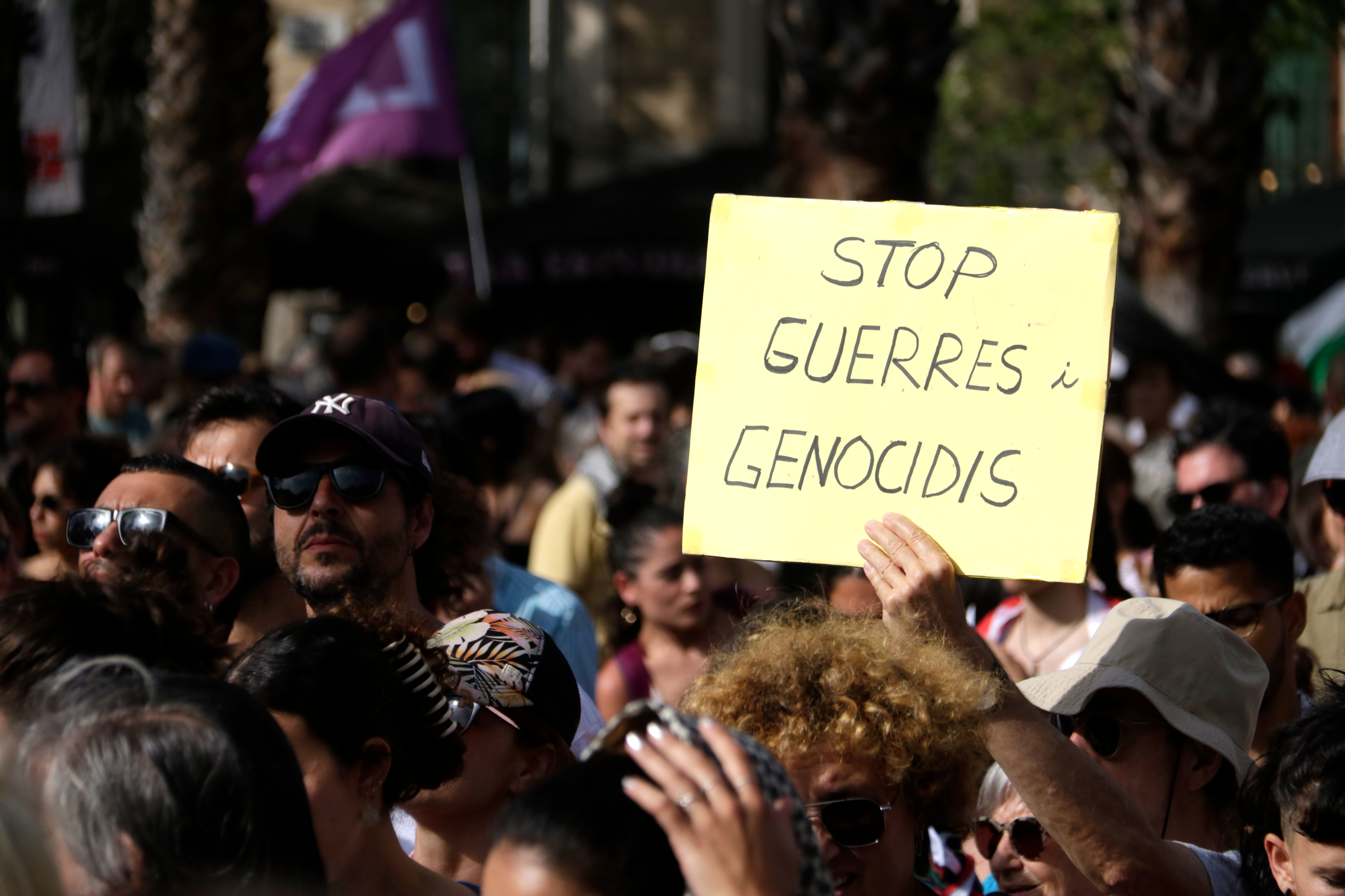 A sign calls for an end to wars and genocides at the protest for Palestine
